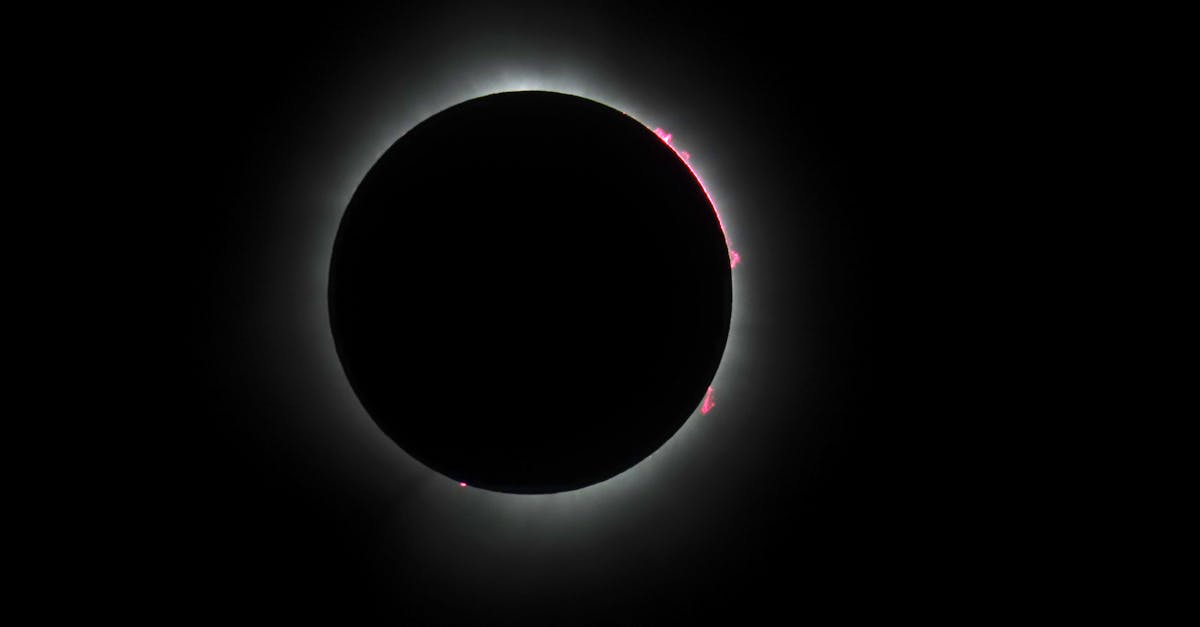 Capture of a solar eclipse showcasing the sun's corona against a black background.