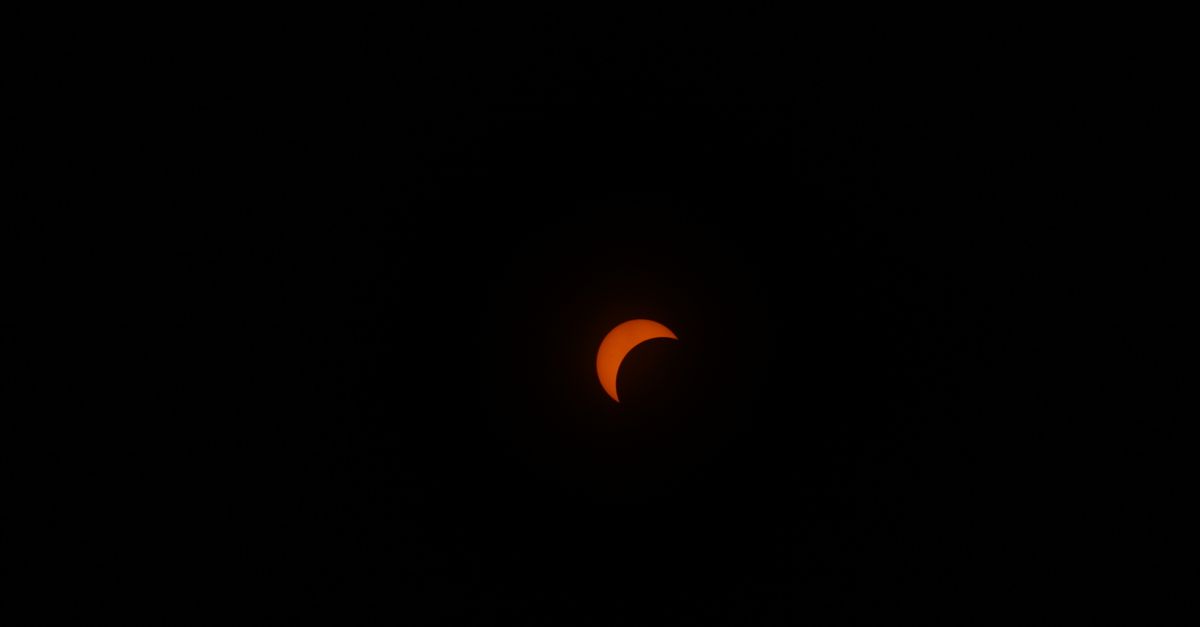 Captivating image of a solar eclipse with a crescent shape against a dark sky.