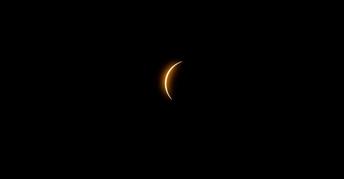 Captivating crescent solar eclipse photographed against the dark night sky in Mazatlán, México.