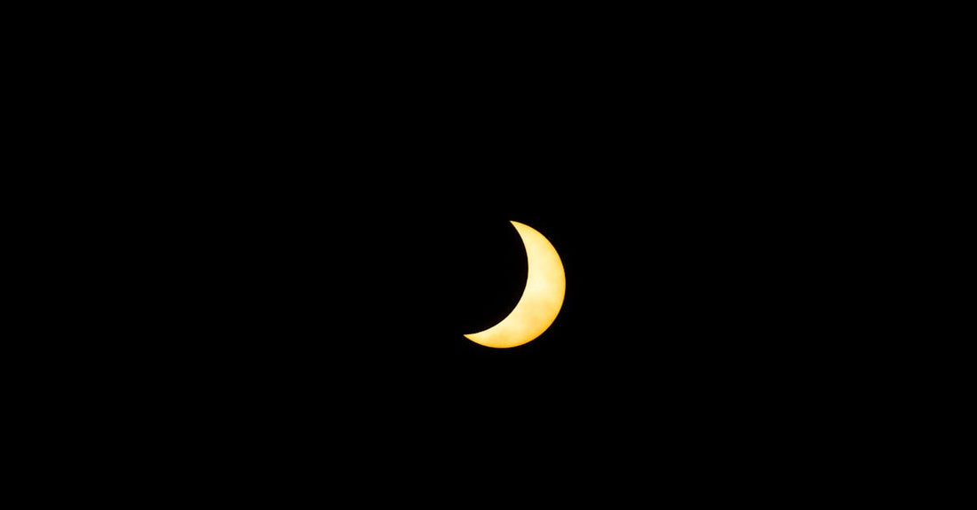 A captivating solar eclipse showing a crescent sun in Mazatlán, México's night sky.