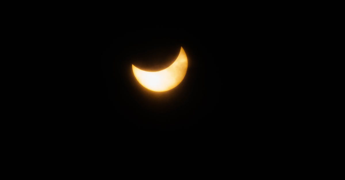 Captivating view of a crescent solar eclipse against a pitch-black sky, highlighting the celestial beauty.
