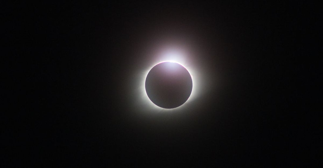 Captivating image of a solar eclipse displaying a radiant glowing corona against a dark sky.