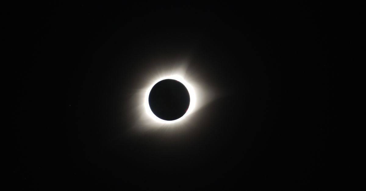 Captivating image of a total solar eclipse showcasing the sun's corona in the dark sky.